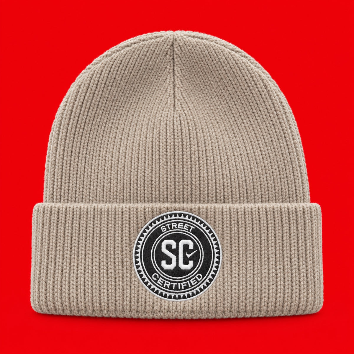 Street Certified Signature Cuffed Beanie in Cream on a red background
