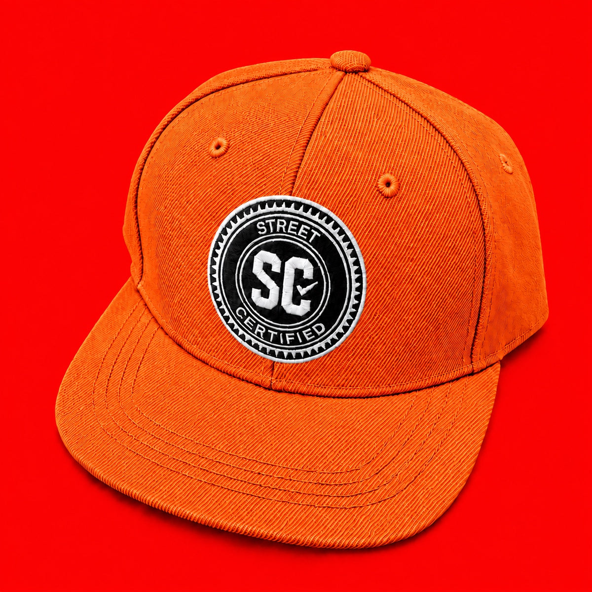 Street Certified Signature Logo Snapback in Orange on a red background