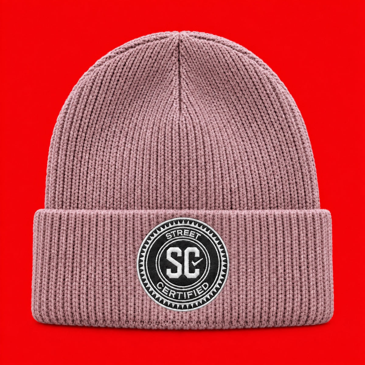 Street Certified Signature Cuffed Beanie in Dusty Pink on a red background