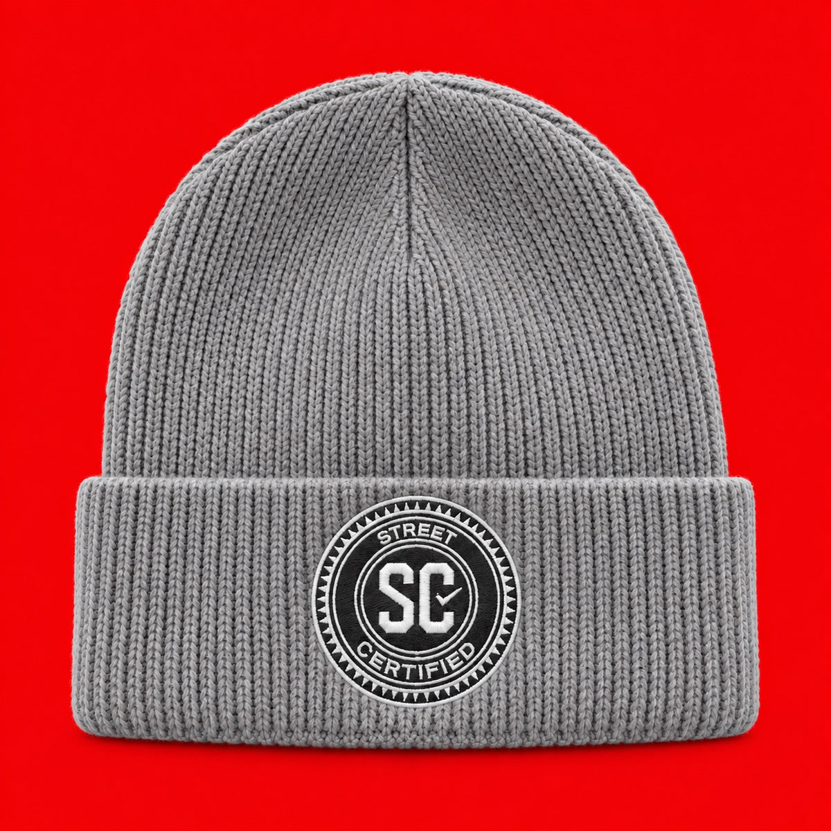 Street Certified Signature Cuffed Beanie in Gray on a red background