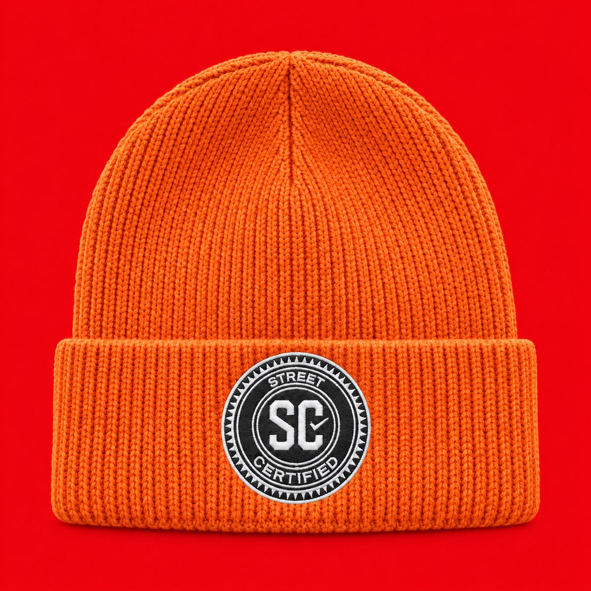 Street Certified Signature Cuffed Beanie in Orange on a red background