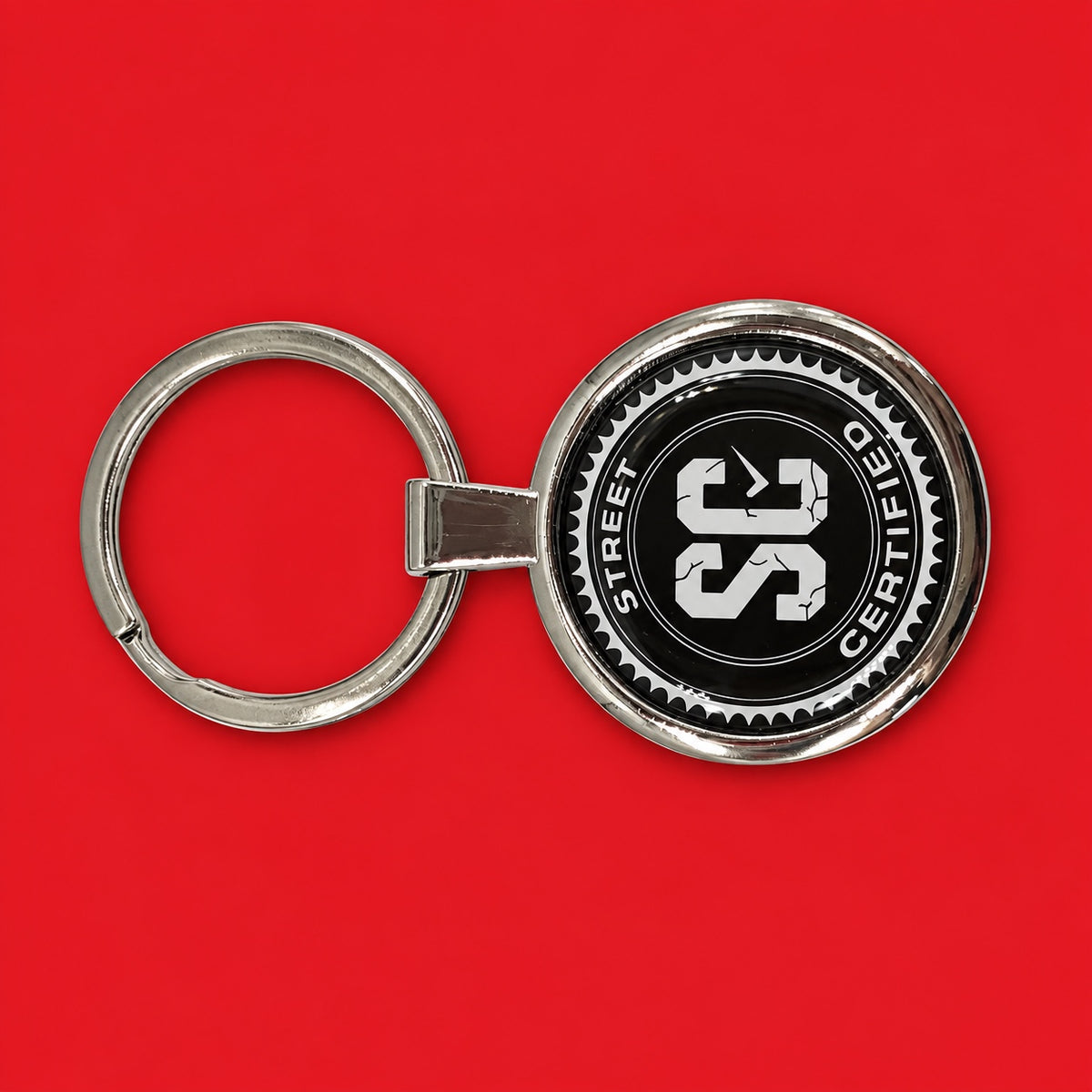 Street Certified Signature Logo Keychain in Black on a red background
