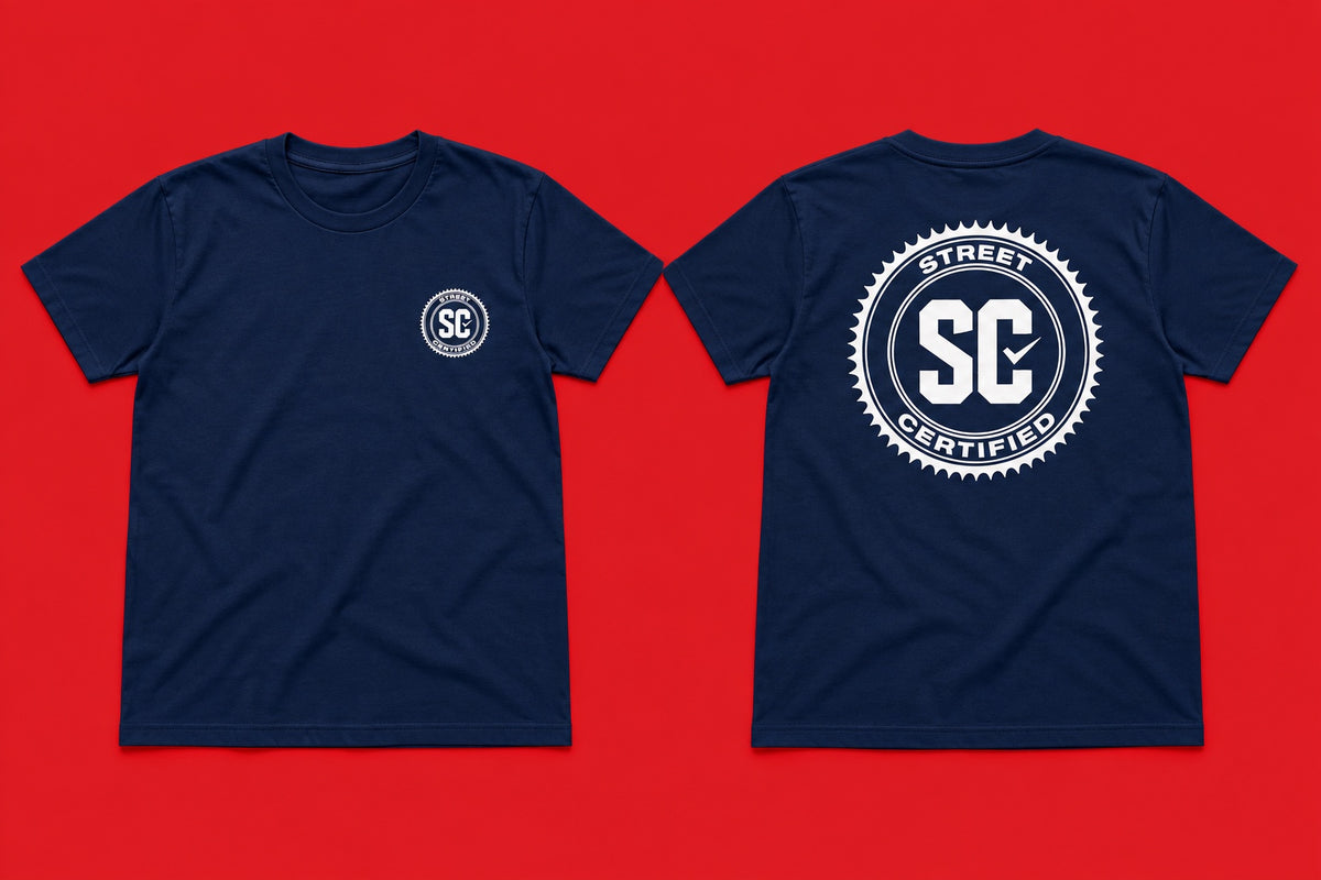 Street Certified Signature Logo Tee in Navy Blue on a red background
